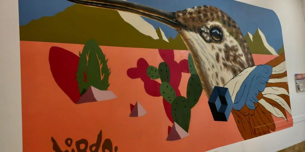 a painting of a bird on a wall