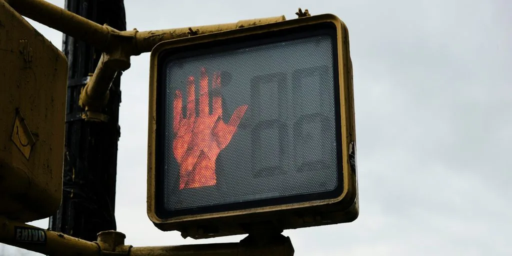 a traffic light with a red hand on it